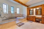 The master bath with a soaking tub and large walk-in shower and double vanities. 